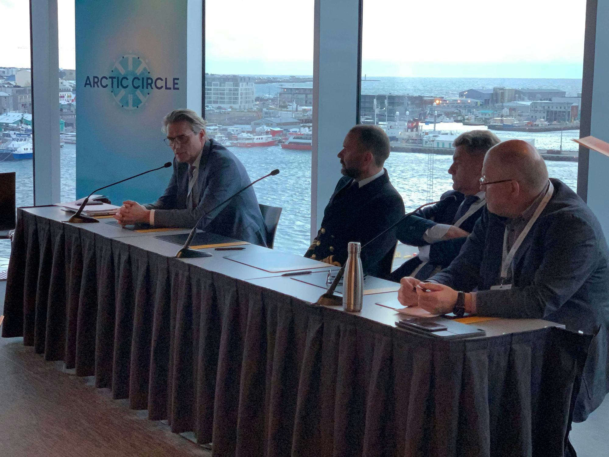 Four men seated at a conference table of Arctic Circle
