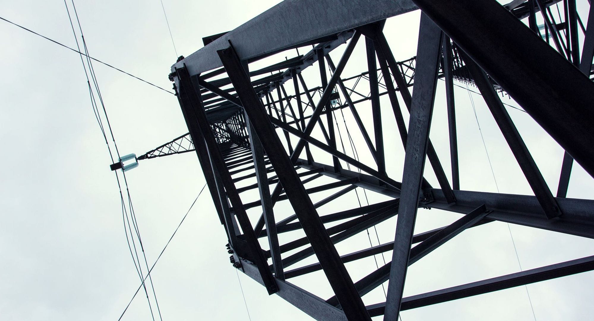 a close-up of an electricity pylon looking up into the sky