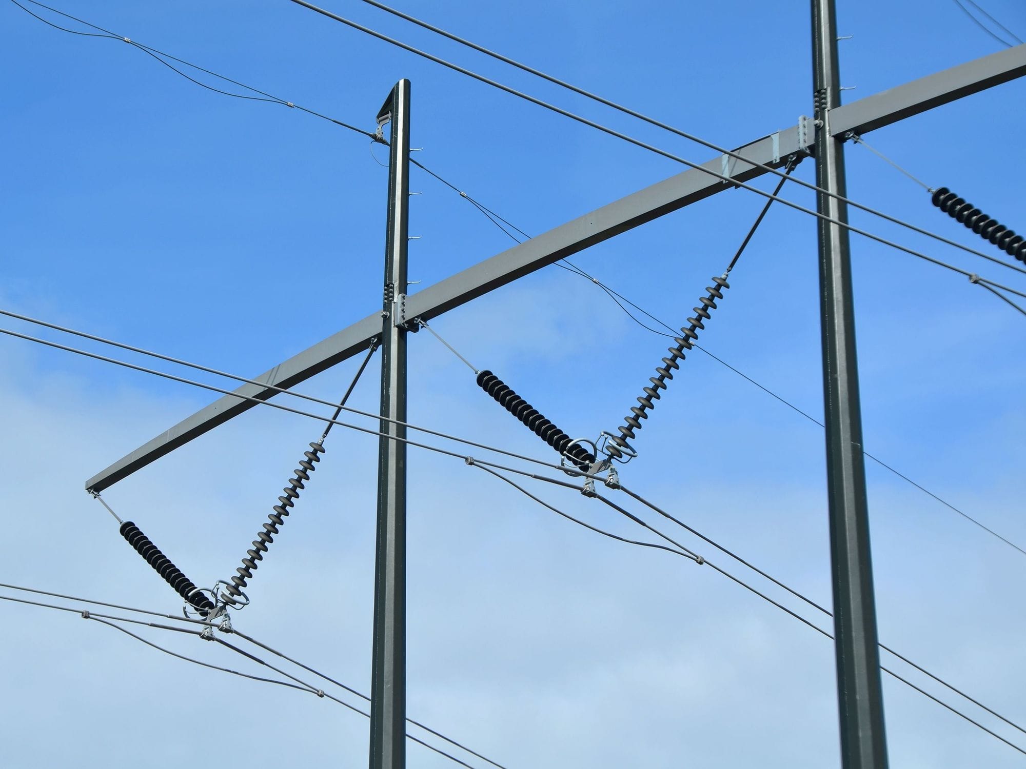 Electric mast in close-up and blue sky in background