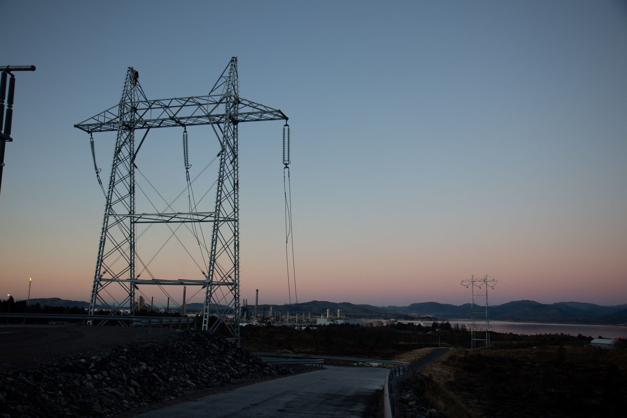 Two masts with a long distance between them in a beautiful pink and bluish sky