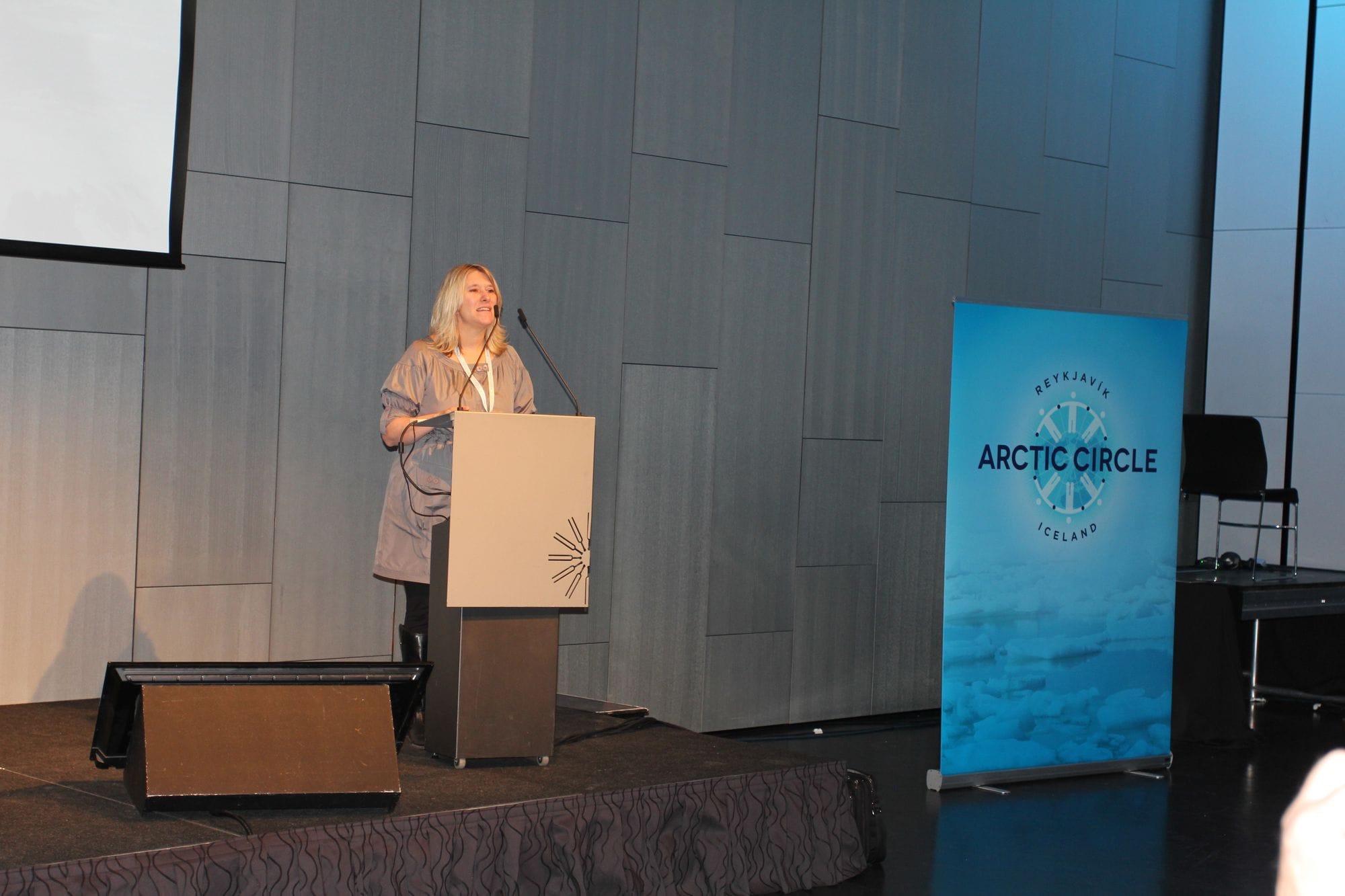 a woman giving speech at a conference