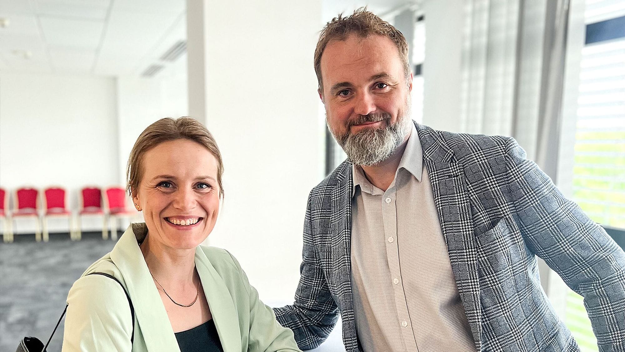 A man and woman posing with smile