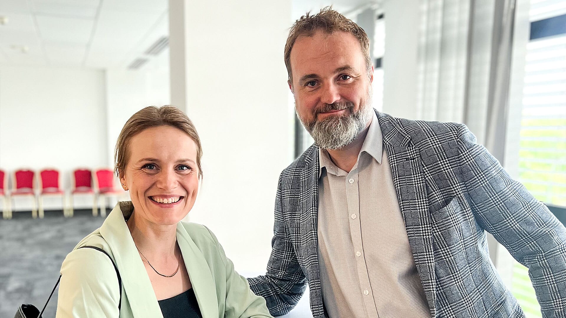 A man and woman posing with smile