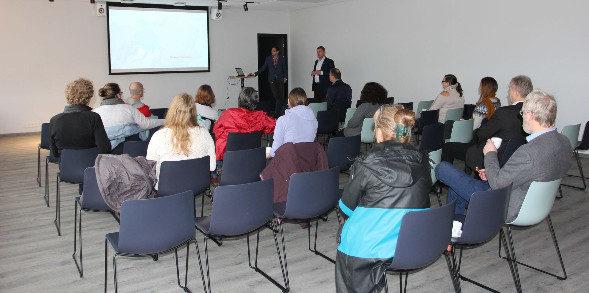 people with their backs turned, seated at the Arctic circle presentation