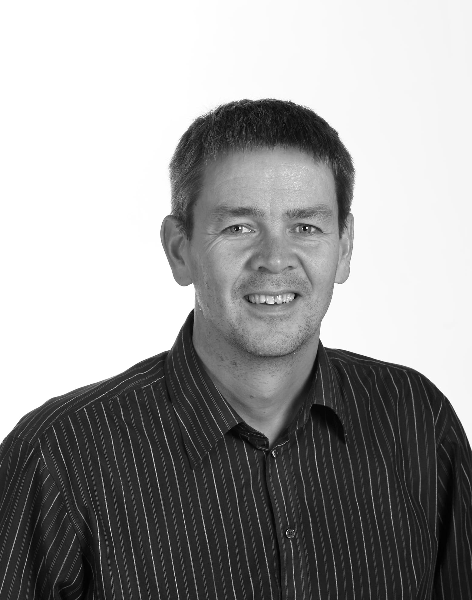 Headshot of a man with stripe shirt
