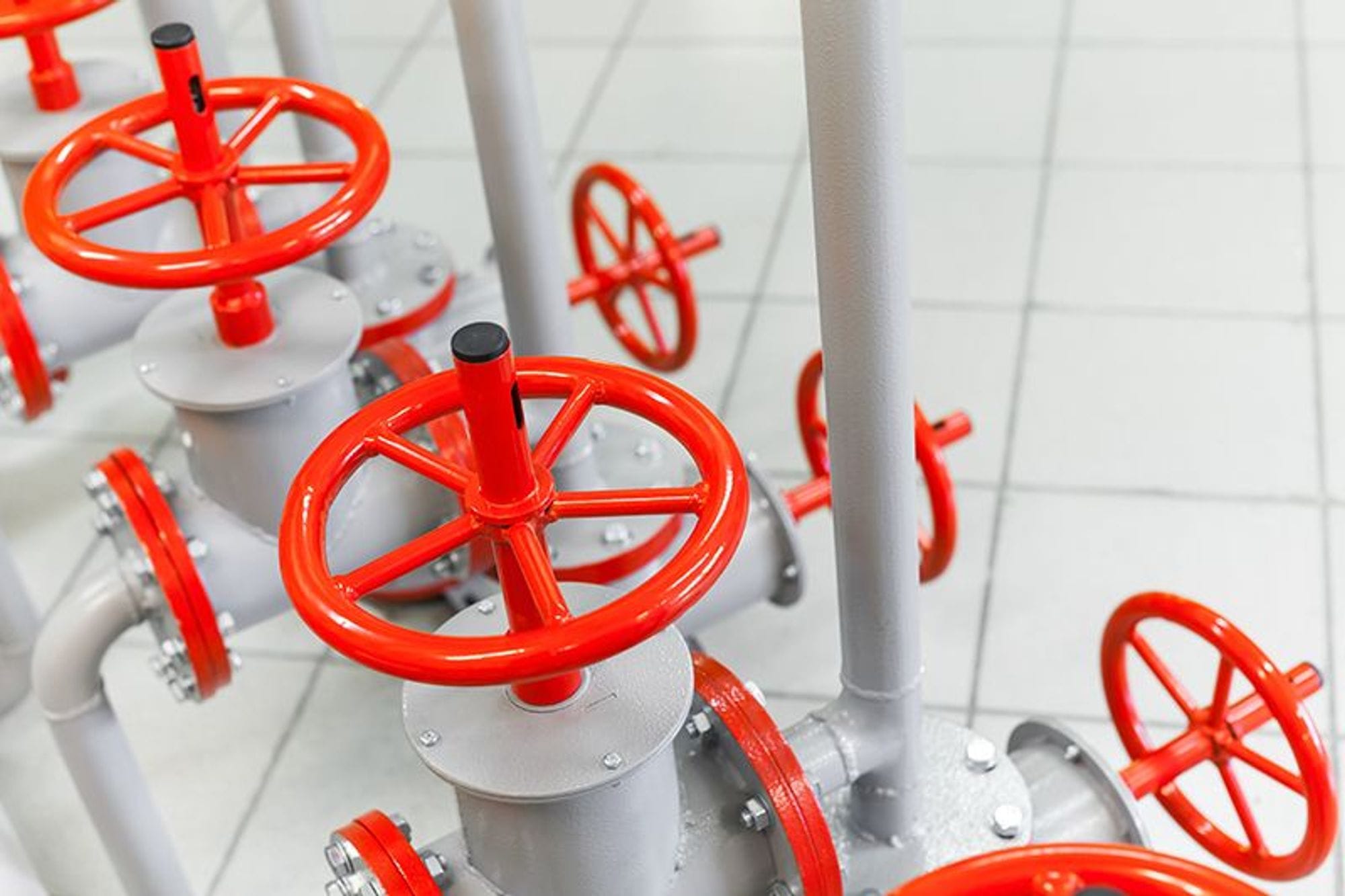 Red round handles on white tubes