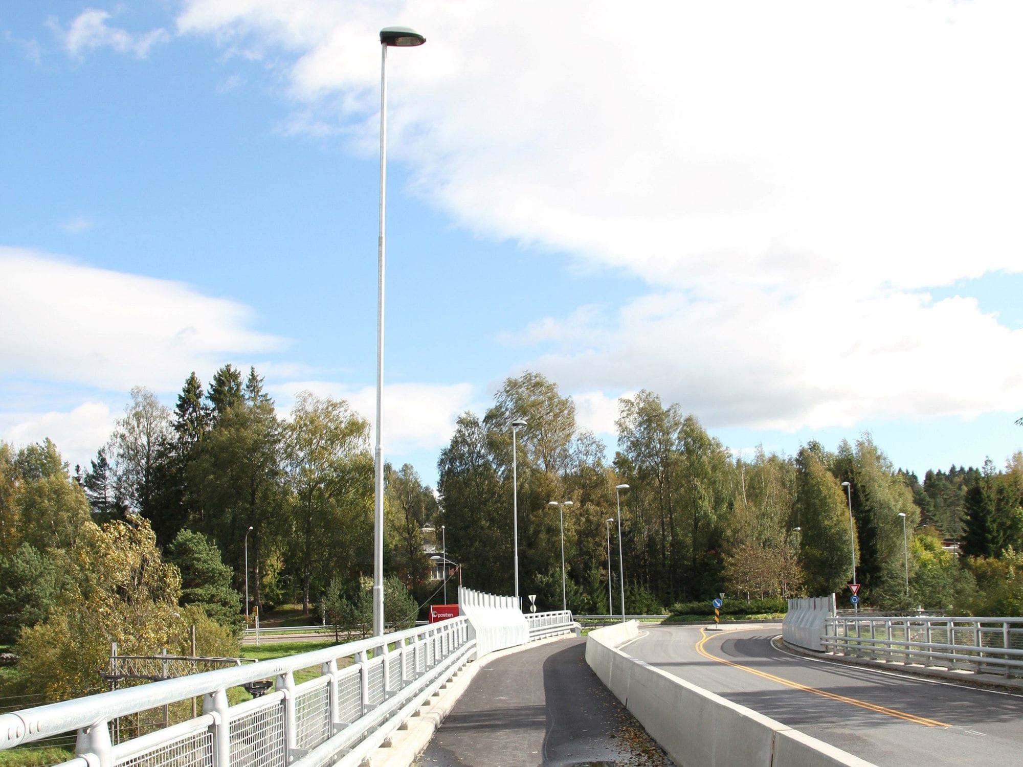 Pedestrian and cycling path at the side of the street demarcated with concrete design and a lush environment