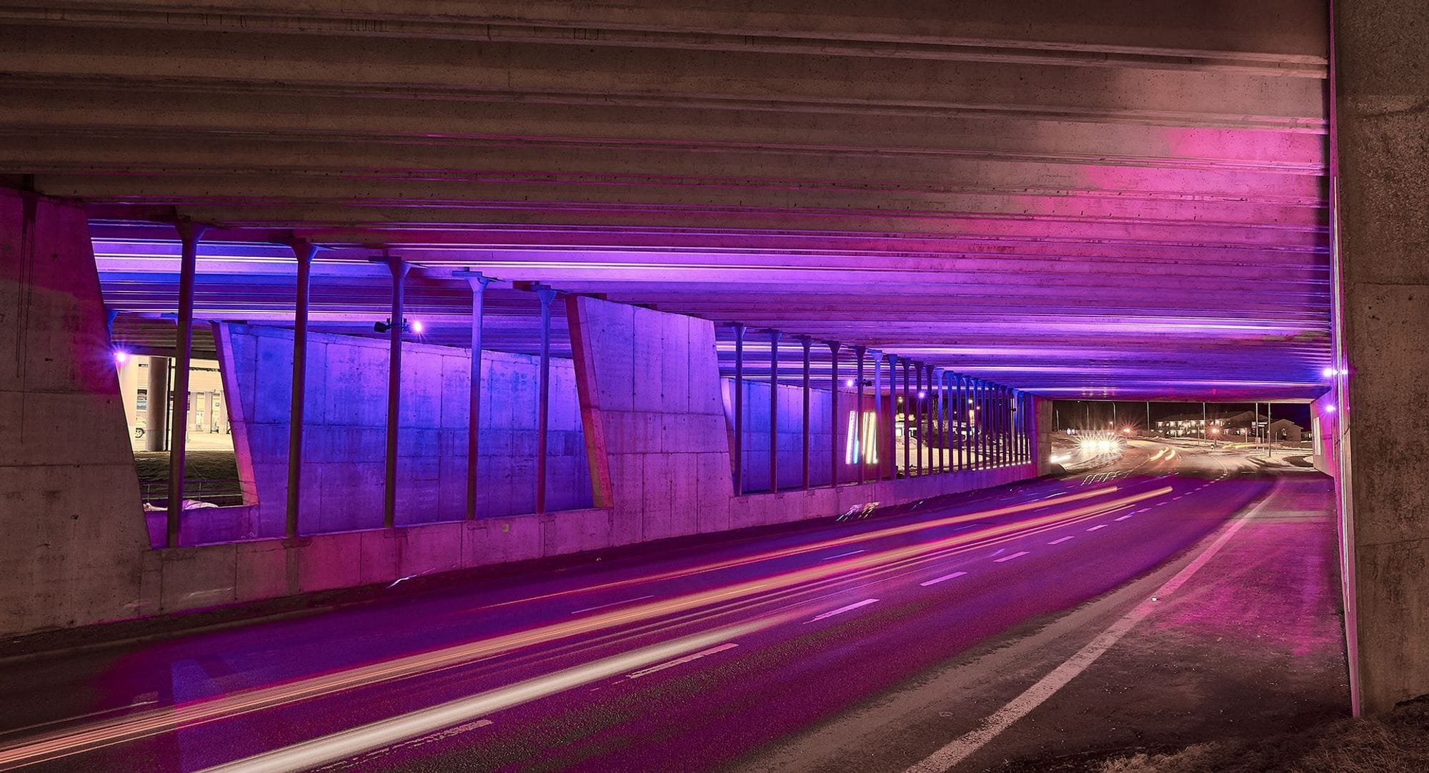multicolour lightning design under a concrete bridge 