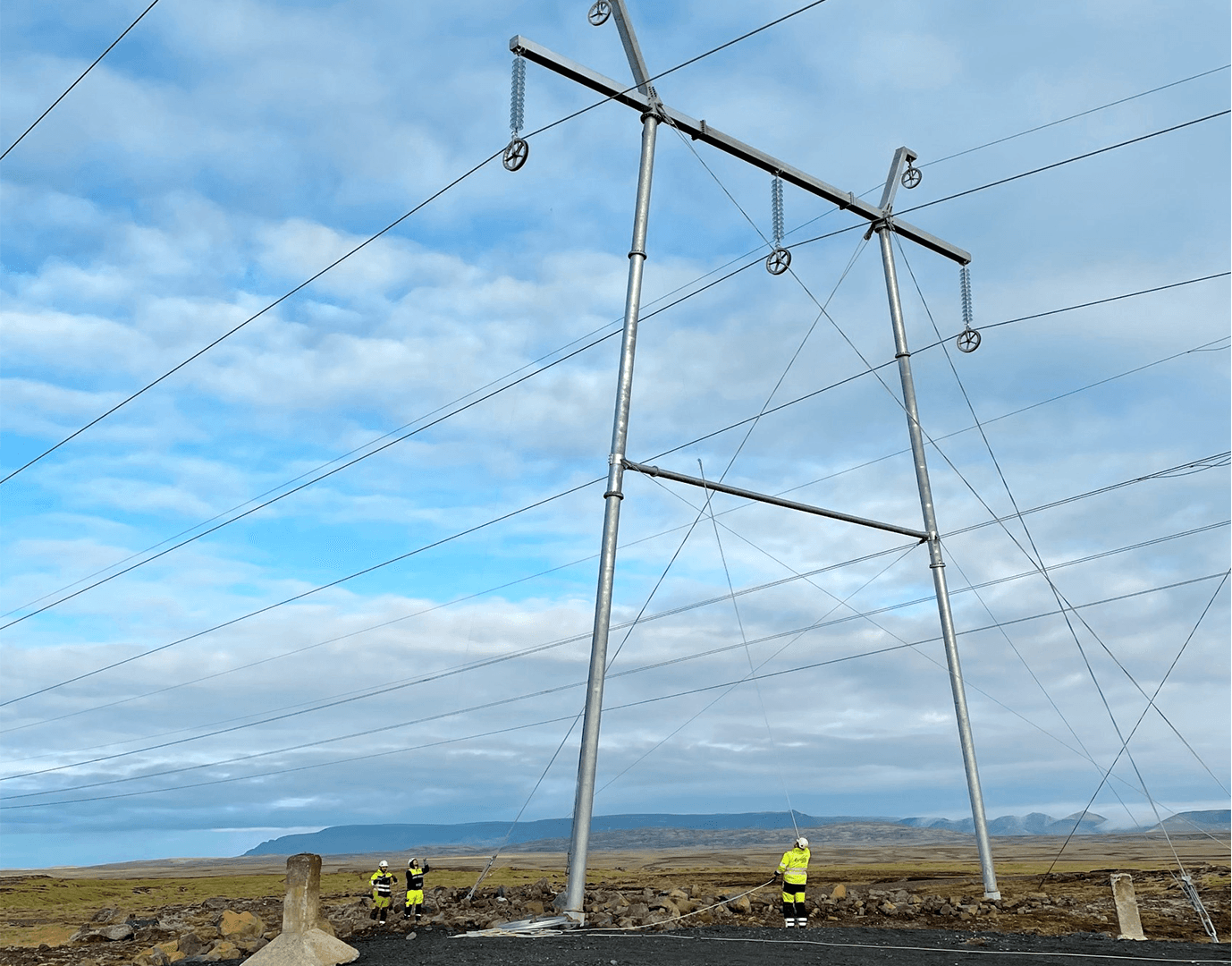 Power mast and man in yellow working clothes
