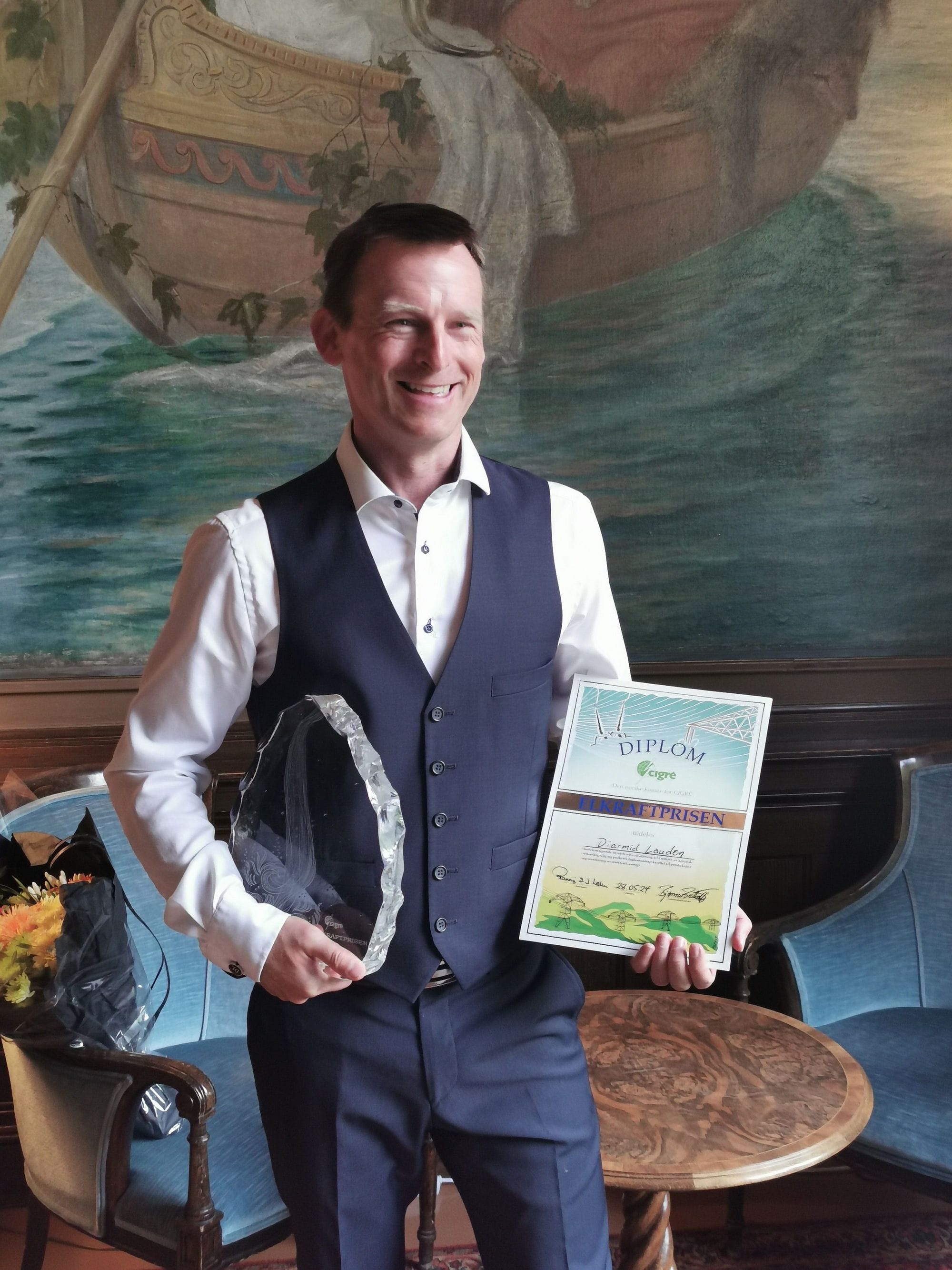 Diarmid posing with the award