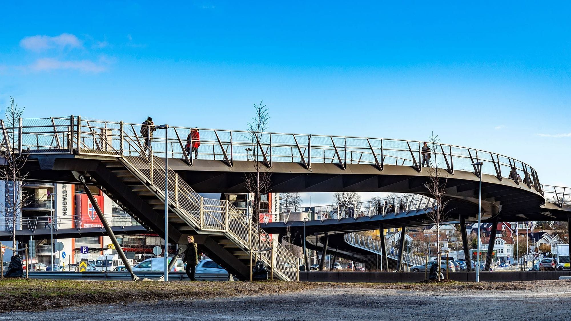Ulleval bridge in daylight with people walking on the bridge.
