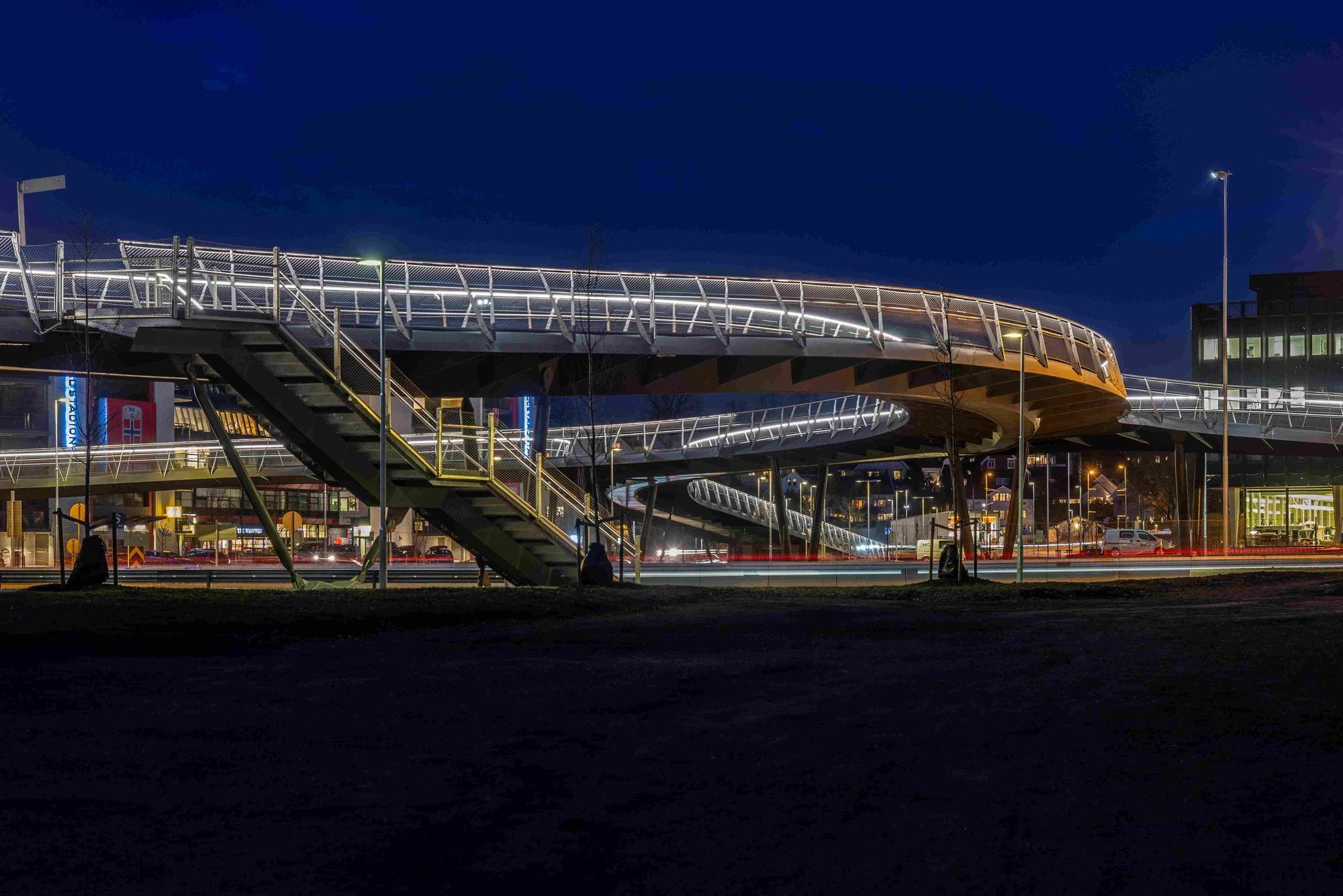 Illuminated footbridge in a dark urban environment