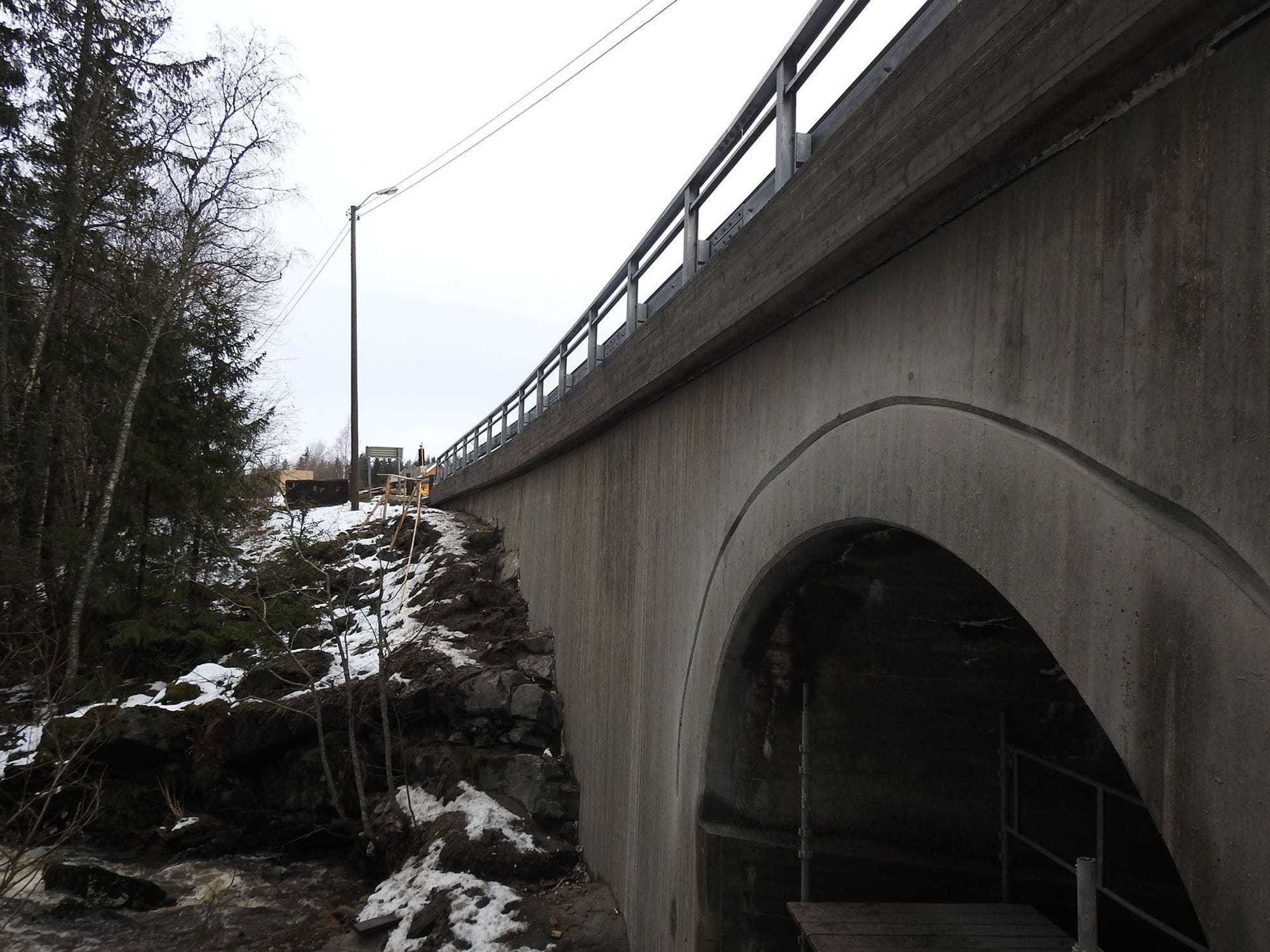 Berger bridge after rehabiliation. Close up of Retaining concrete wall with new railing on top of the bridge. 