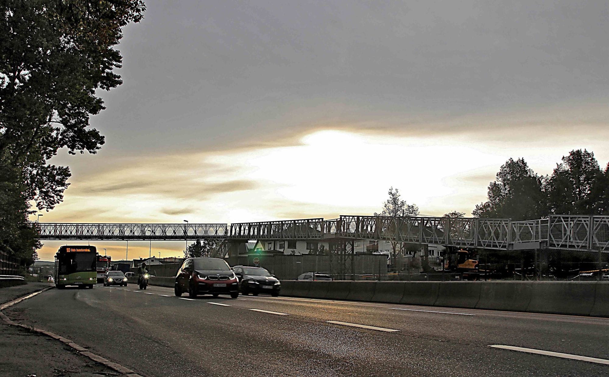 Cars driving on a road and new footbridge going over the road