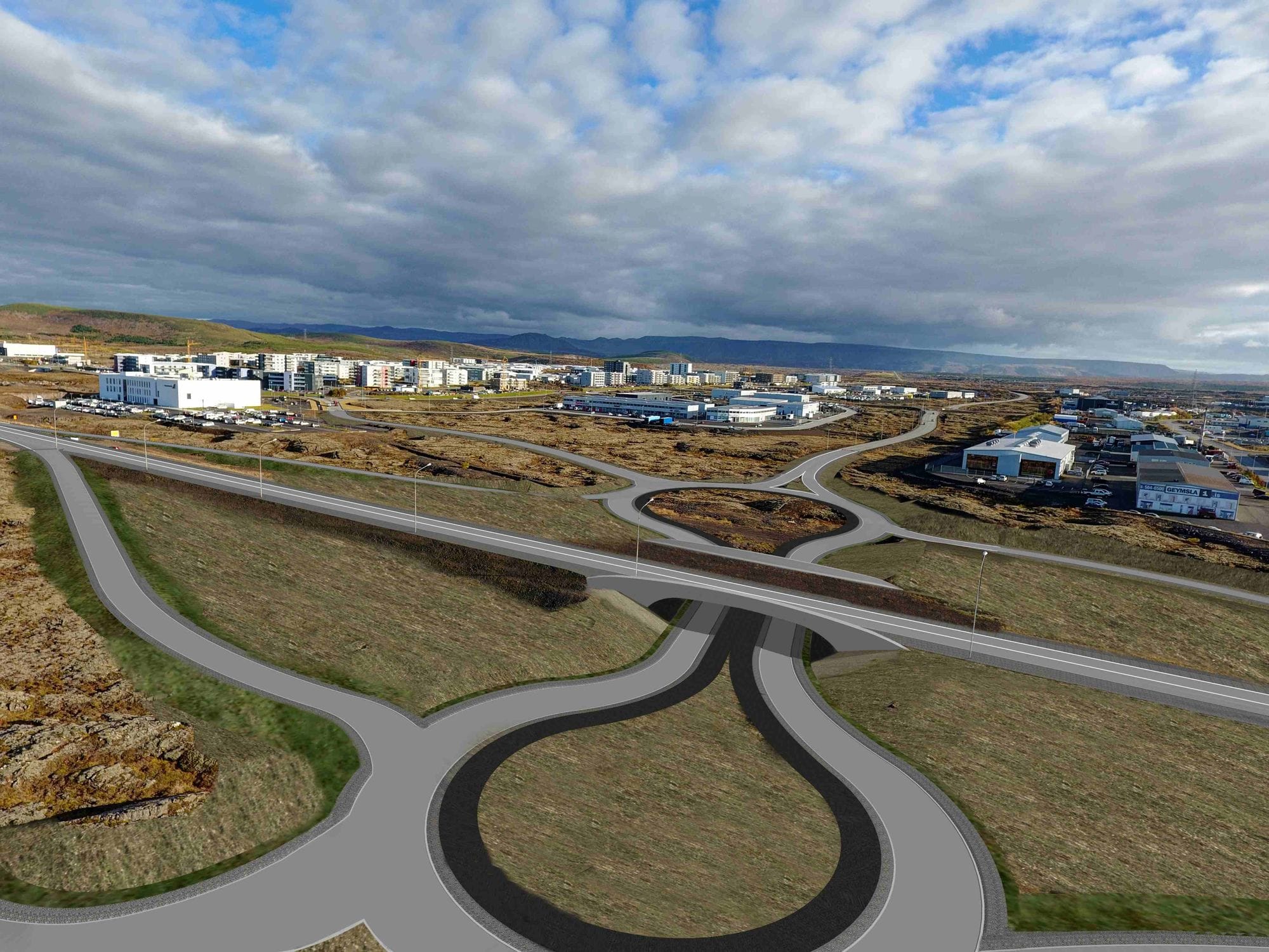 Overview of a populated area and new roads in lavafields surrounding the buildings