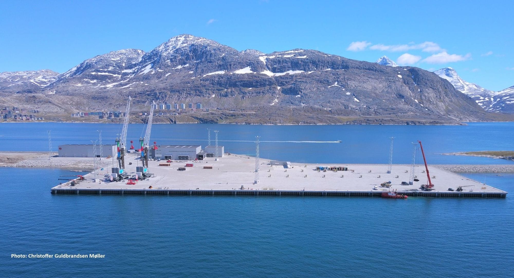 The big boat harbor in Nuuk from surrounded by the sea and with big mountains in the background