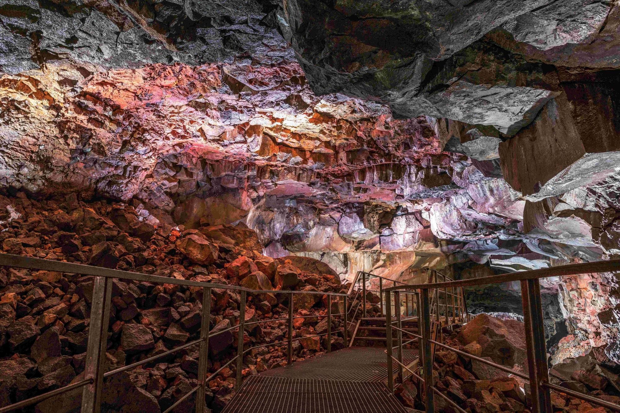 A footbridge inside a reddish and lighted cave