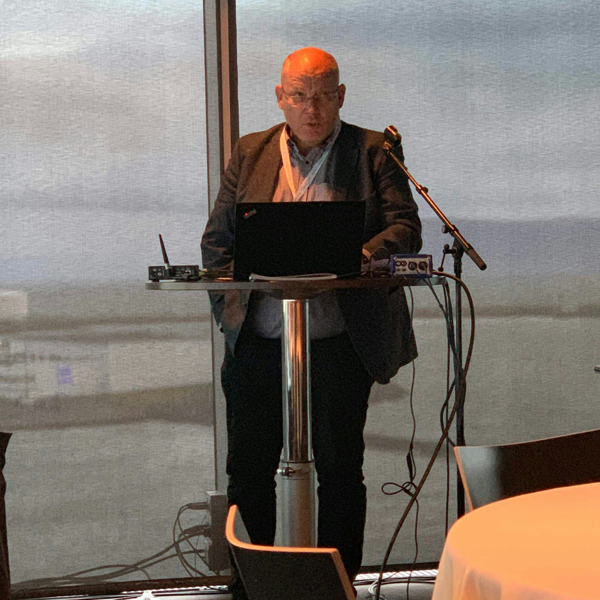 A man speaking at a conference