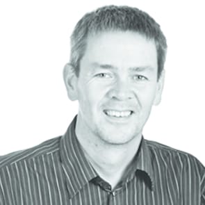 Headshot of a man wearing a stripe shirt