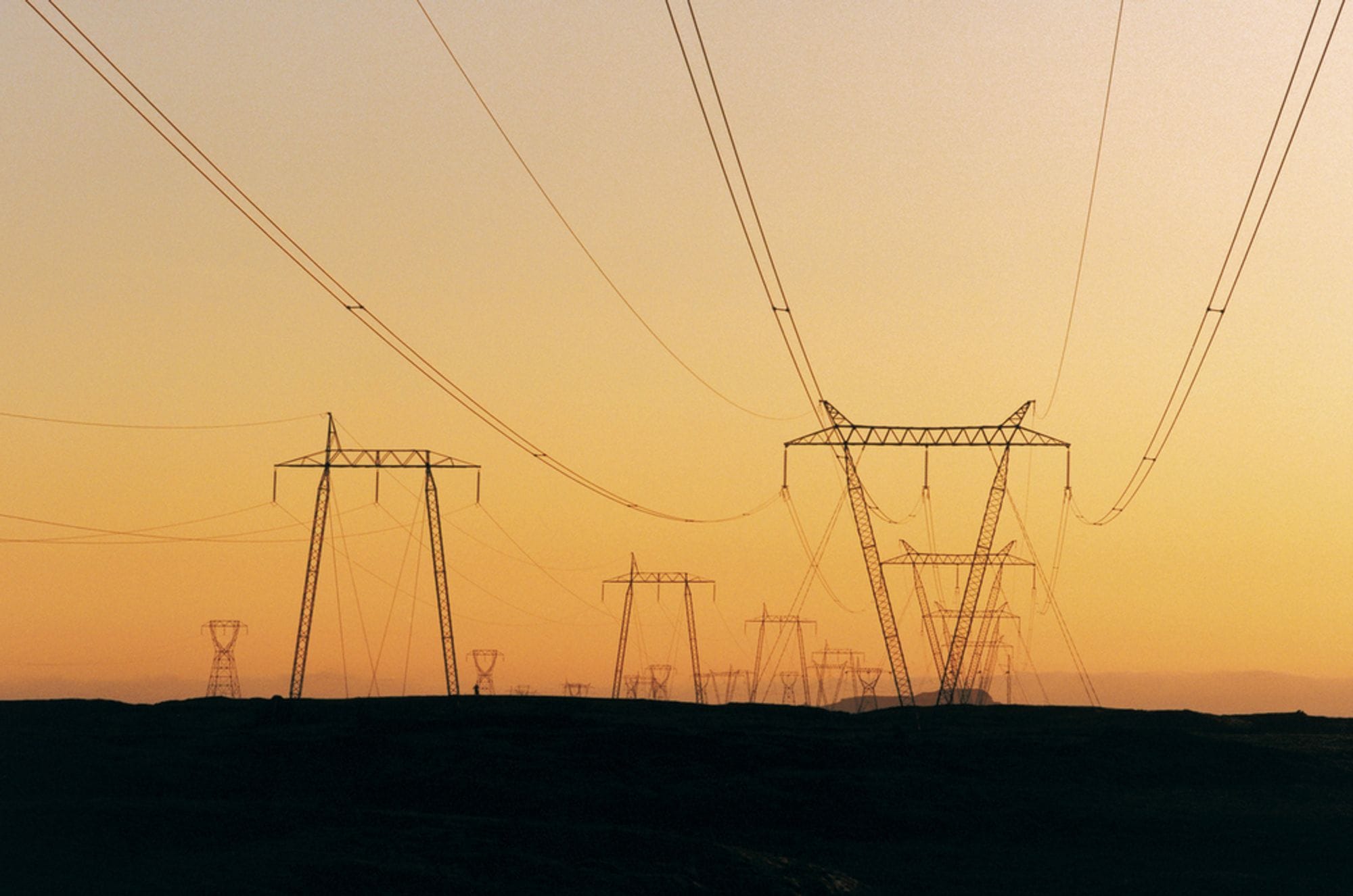 Overhead lines at Hellisheiði during sunset.