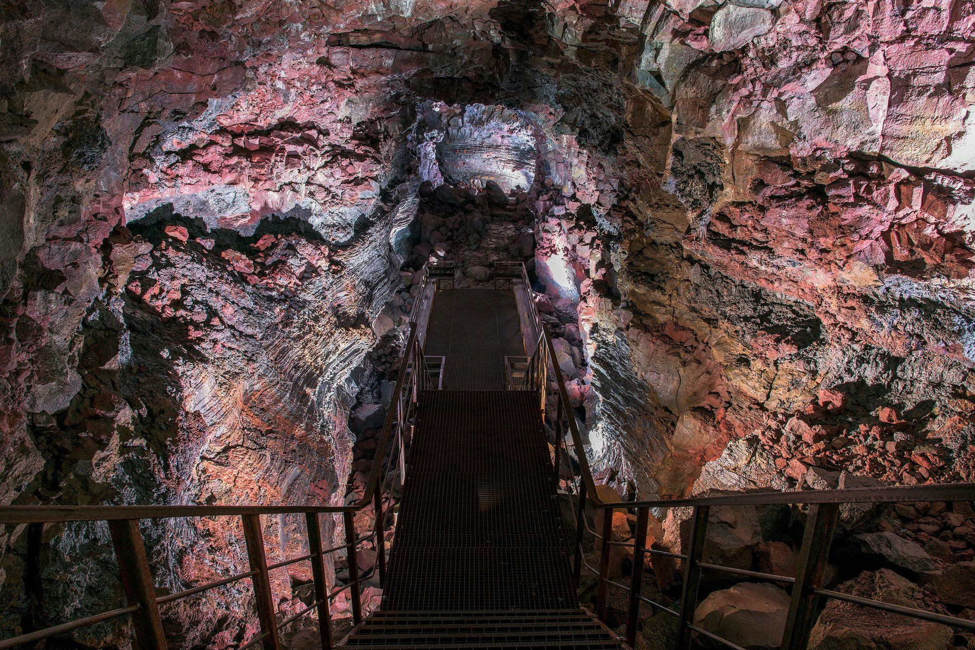 metal stairs leading down to a cave