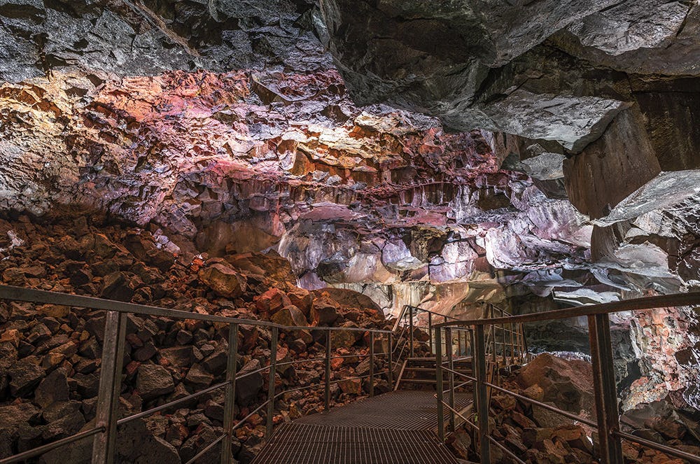 Interior of a red stone cave with metal stairs