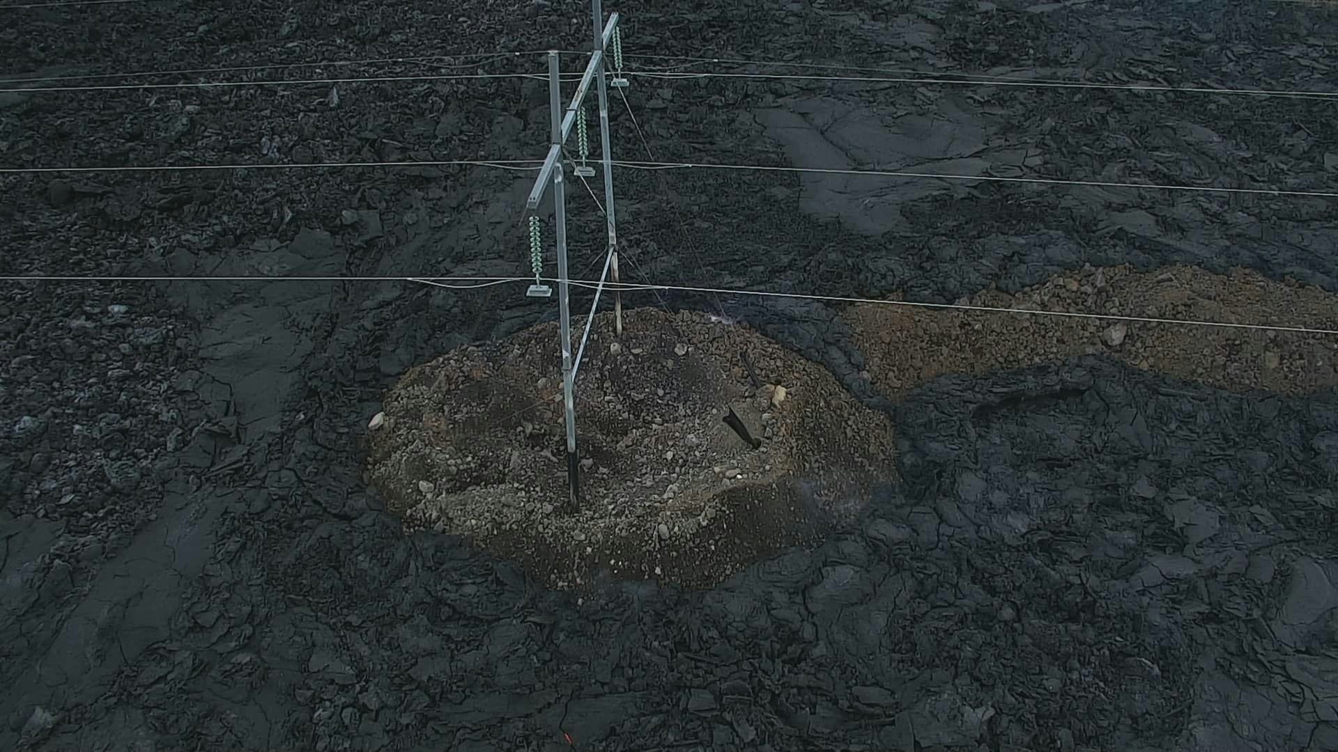 A high voltage lines wtih lava around it.
